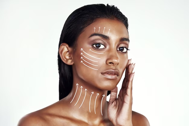 Close-up beauty portrait showing facial massage lines and lymphatic drainage directions on a woman's glowing skin against a white background